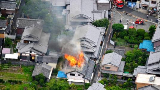 TAKATSUKI, JAPAN - JUNE 18: (CHINA OUT, SOUTH KOREA OUT) In this aerial image, fire breaks out at a house after the magnitude 6.1 earthquake on June 18, 2018 in Takatsuki, Osaka, Japan. A powerful earthquake struck Osaka and neighbouring prefectures, killing at least three people and disrupting morning train services and knocking out power in a widespread area. The quake, which hit at 7:58 am, registered a lower 6 on the Japanese seismic intensity scale of 7 in northern Osaka Prefecture and an upper 5 in southern Kyoto Prefecture, according to the Meteorological Agency. (Photo by The Asahi Shimbun via Getty Images)