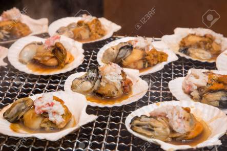Seafood grill - street food in Tsukiji fish market, Tokyo, Japan.